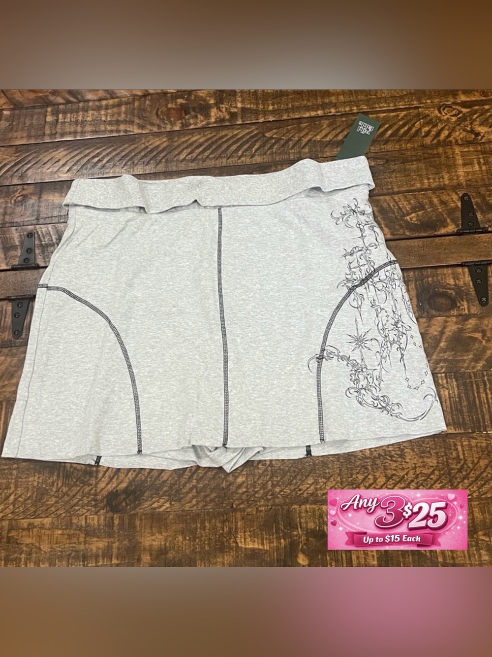 Gray skort with black contrast stitching and graphic detailing.